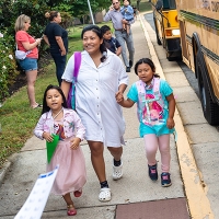 Parent walking their students to school